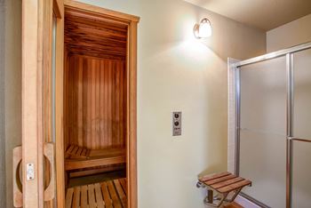 a sauna room with a shower and a wooden bench at Valley Plaza Villages, Pleasanton, 94566